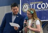 Congressman TJ Cox enlists the help of Mary Kathryn Norris to read submitted questions during a town hall held Saturday at Hanford West High School, the first such event of his first term.